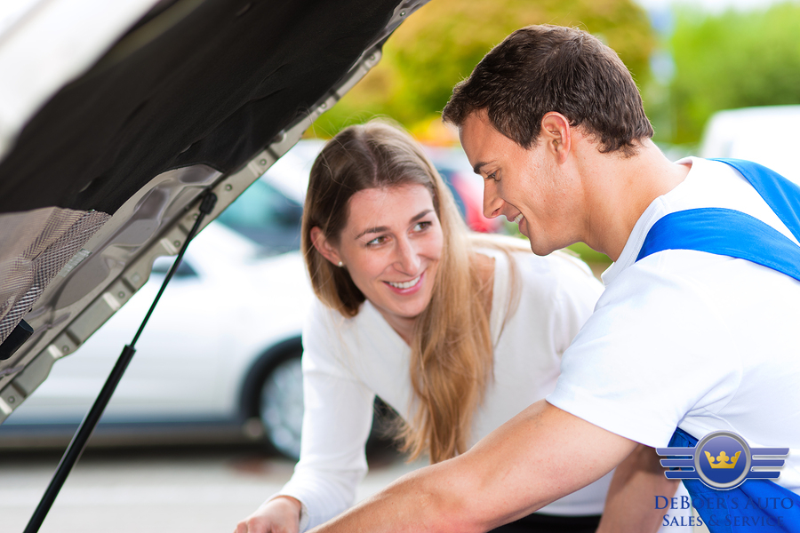 bigstock-Woman-talking-to-a-car-mechani-13929317