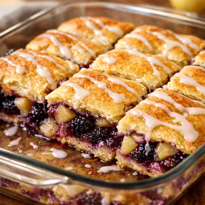 The image features a freshly baked dish of Blackberry and Pear Crescent Roll Bars displayed in a 9 x 13 baking dish The goldenbrown top layer of cresc