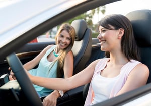 Women on a road trip talking and looking very happy