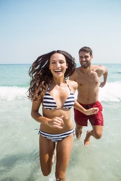 happy couple smiling at the beach