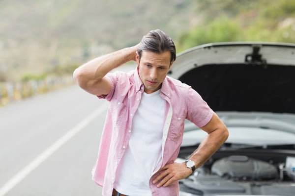 Stressed man waiting assistance after a car breakdown at the side of the road