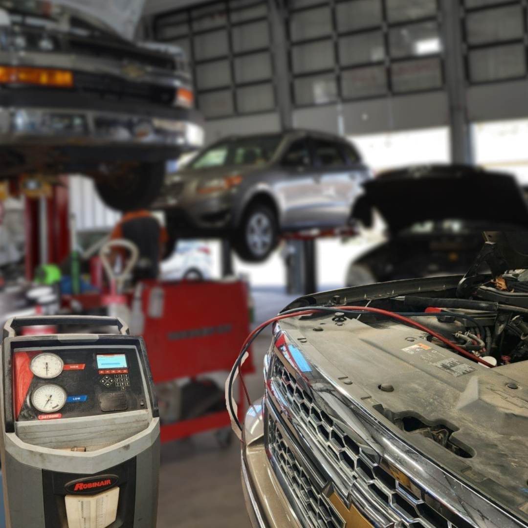 AC Charging on a truck with cars on lifts in background