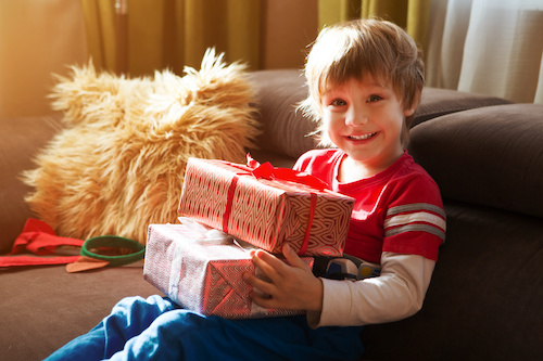 kid with Christmas presents