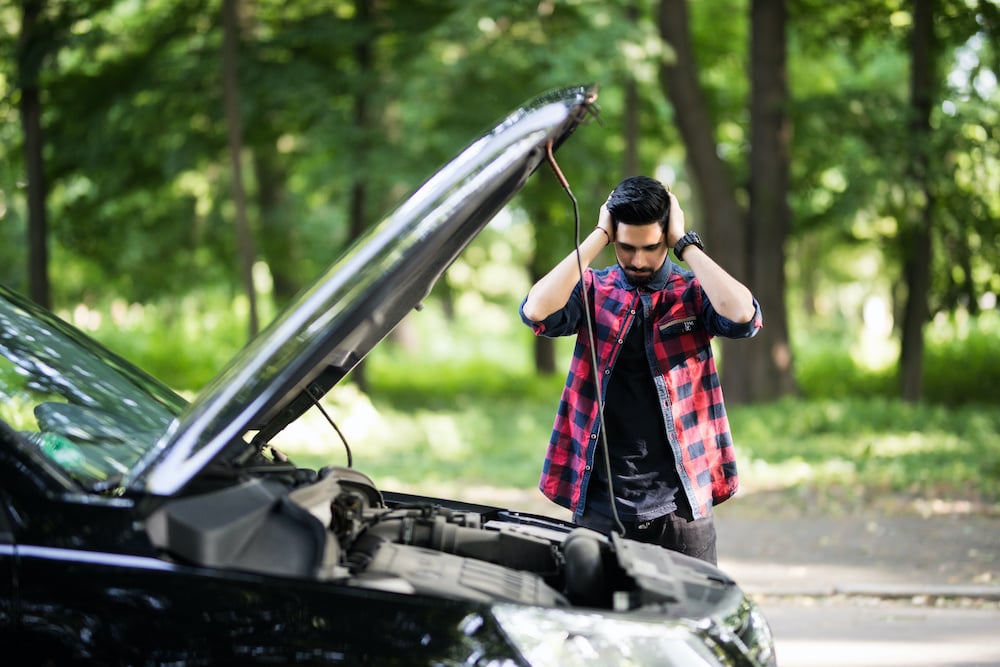 stranded man with car hood up