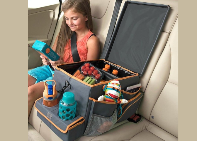 child in back seat of car with snacks and organizer