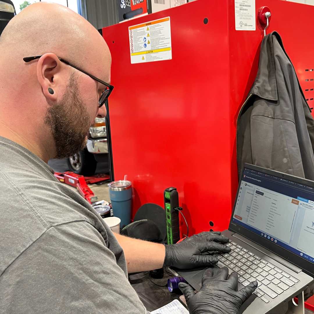 auto technician on computer