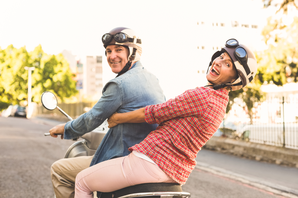 couple riding scooter having fun