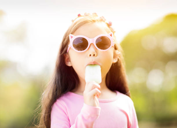 young girl eating popsicle